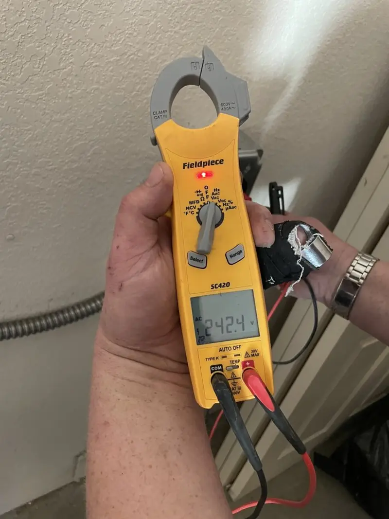 Voltage testing with clamp meter during Recessed Lighting Installation in Richmond Heights